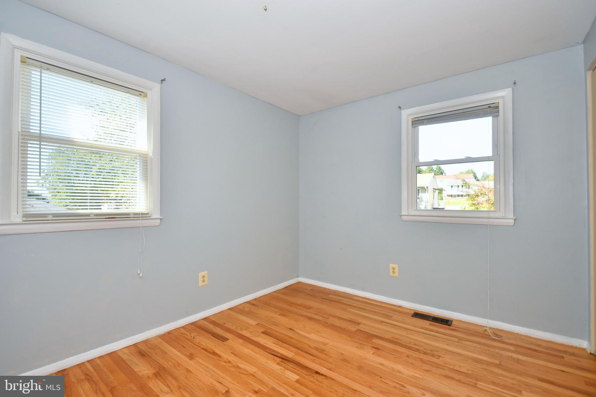 4704 Ebenezer Road Nottingham, MD 21236 - Photo 18 of 56 a view of an empty room with wooden floor and a window