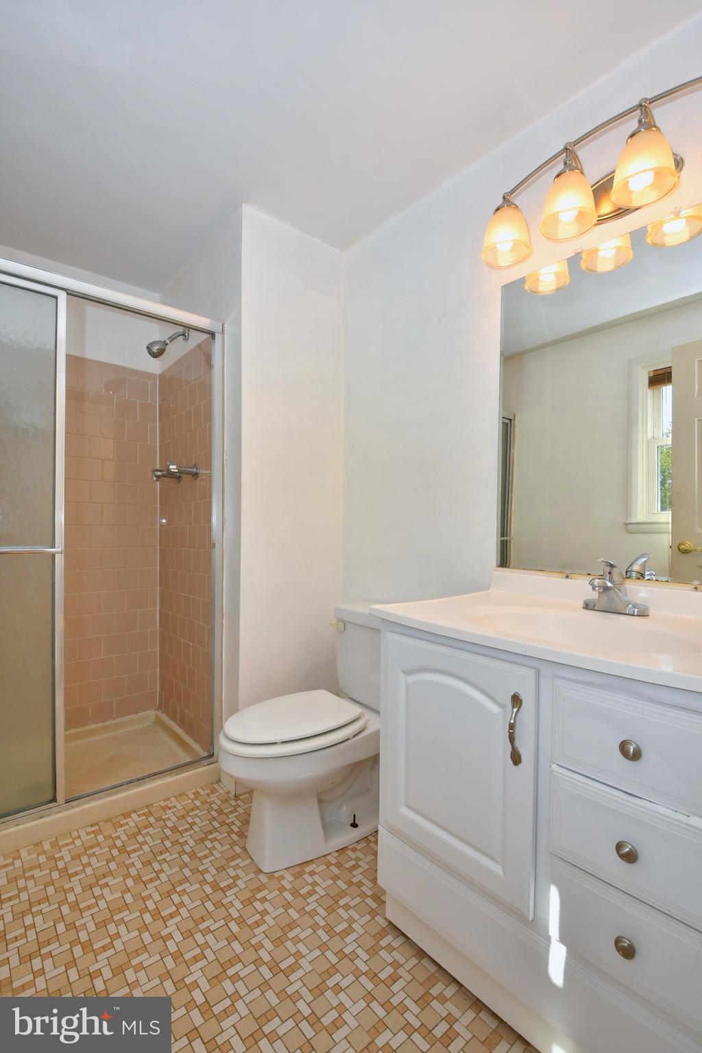 4704 Ebenezer Road Nottingham, MD 21236 - Photo 19 of 56 a bathroom with a sink a toilet a mirror and shower