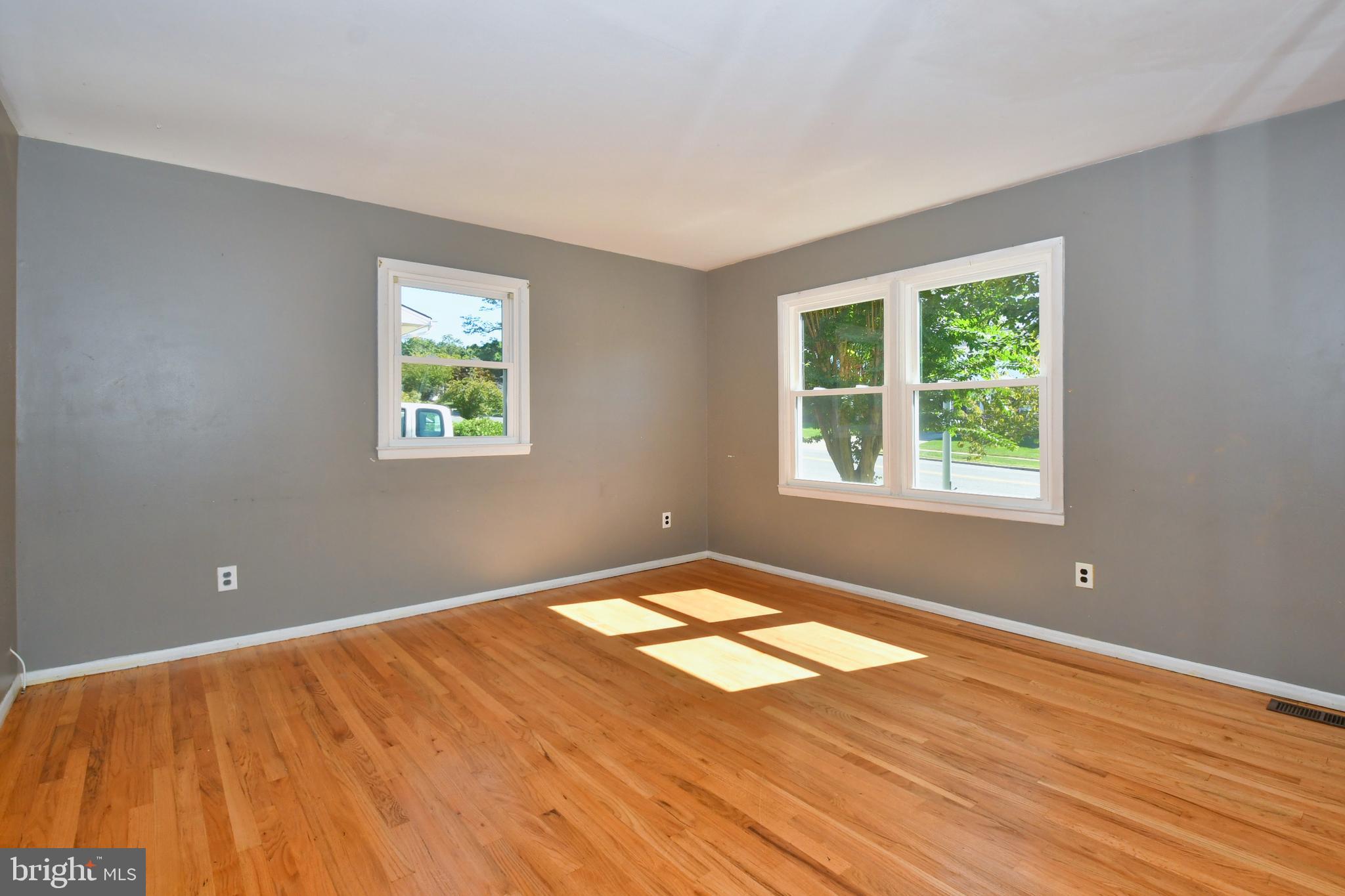 4704 Ebenezer Road Nottingham, MD 21236 - Photo 3 of 56 a view of an empty room with wooden floor and a window