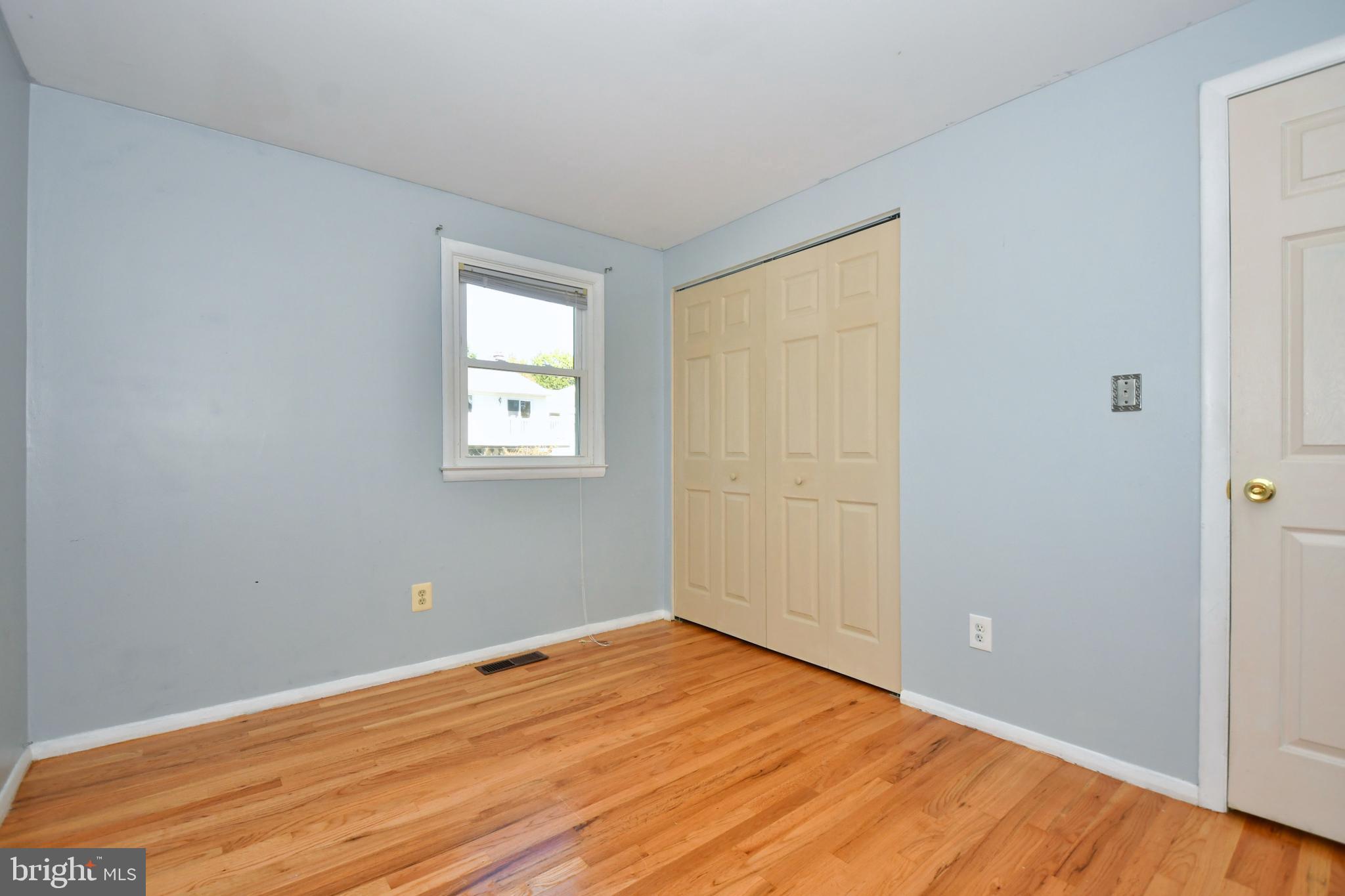 4704 Ebenezer Road Nottingham, MD 21236 - Photo 22 of 56 an empty room with wooden floor and windows