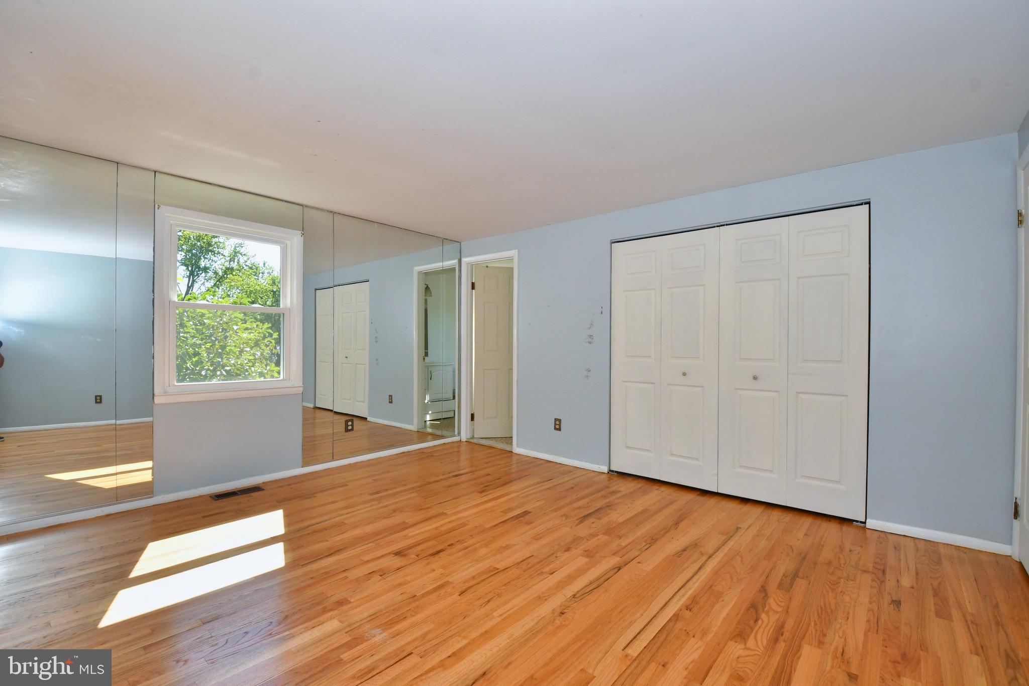 4704 Ebenezer Road Nottingham, MD 21236 - Photo 24 of 56 a view of an empty room with wooden floor and a window