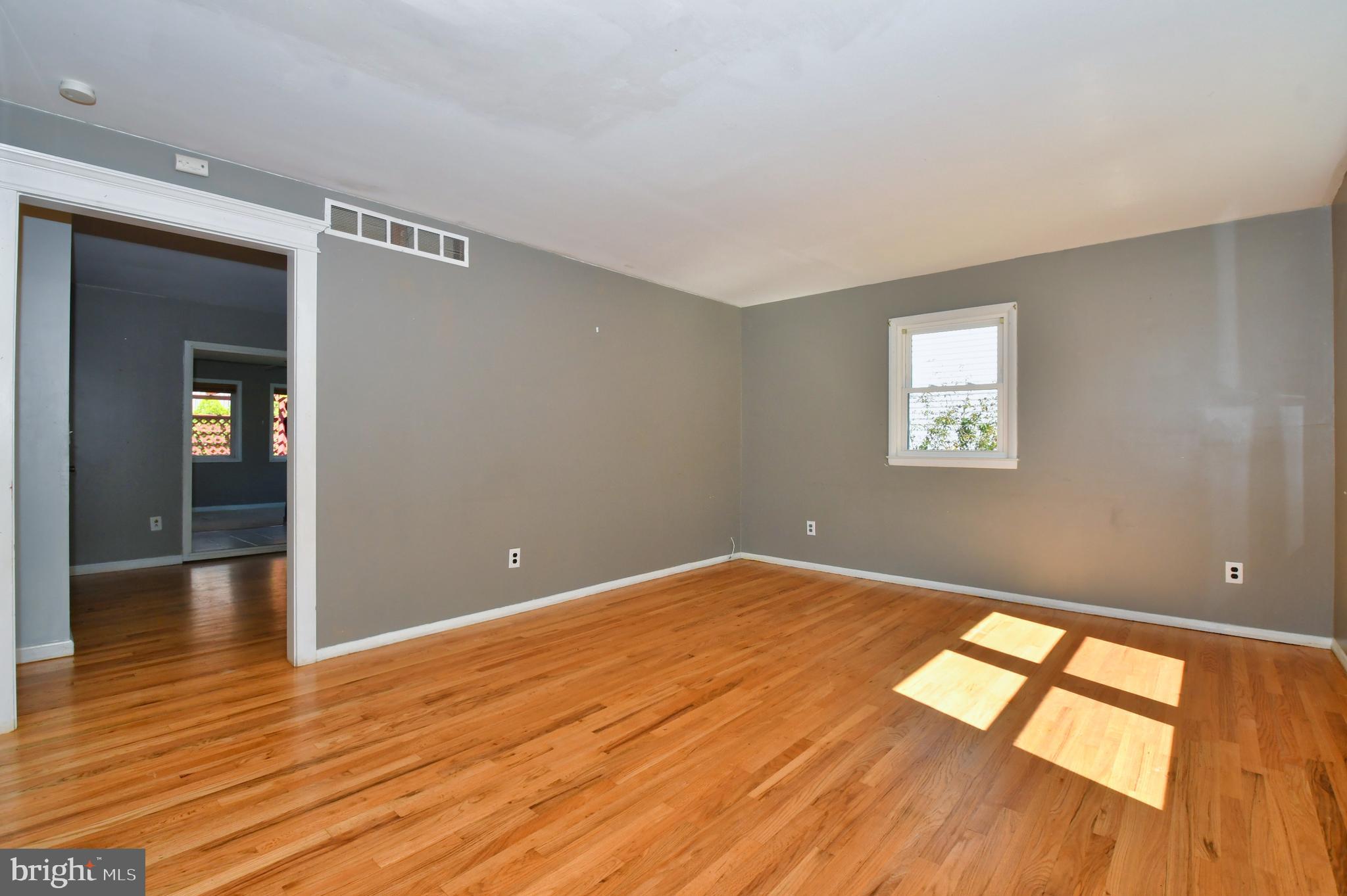 4704 Ebenezer Road Nottingham, MD 21236 - Photo 4 of 56 wooden floor in an empty room with a window