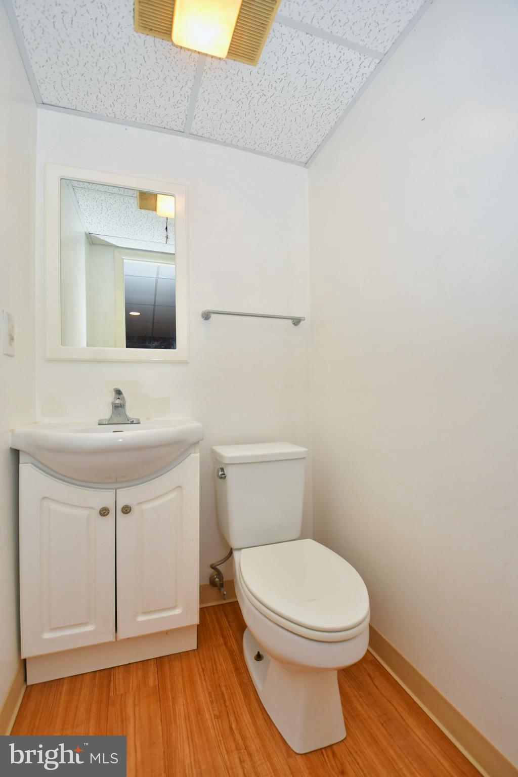 4704 Ebenezer Road Nottingham, MD 21236 - Photo 38 of 56 a bathroom with a toilet a sink and mirror