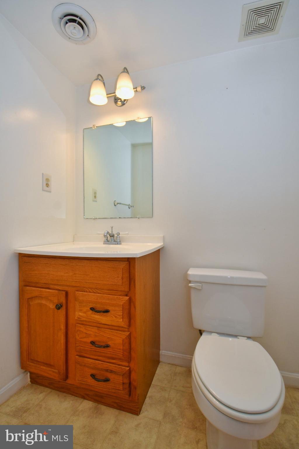 4704 Ebenezer Road Nottingham, MD 21236 - Photo 39 of 56 a bathroom with a toilet sink and mirror