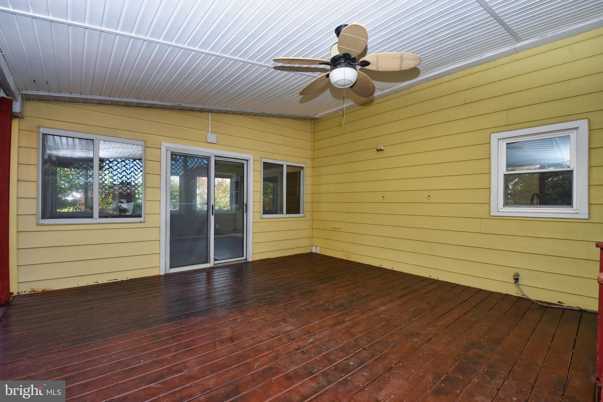 4704 Ebenezer Road Nottingham, MD 21236 - Photo 44 of 56 a view of an empty room with a window and wooden floor