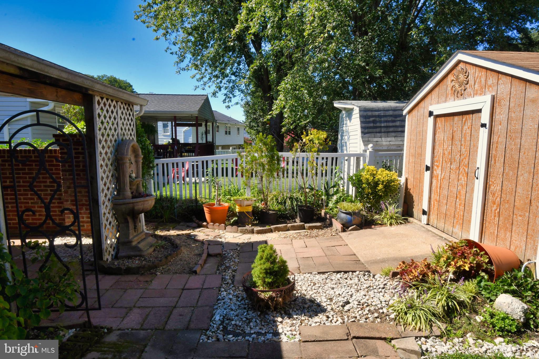4704 Ebenezer Road Nottingham, MD 21236 - Photo 52 of 56 a view of a house with potted plants and a bench