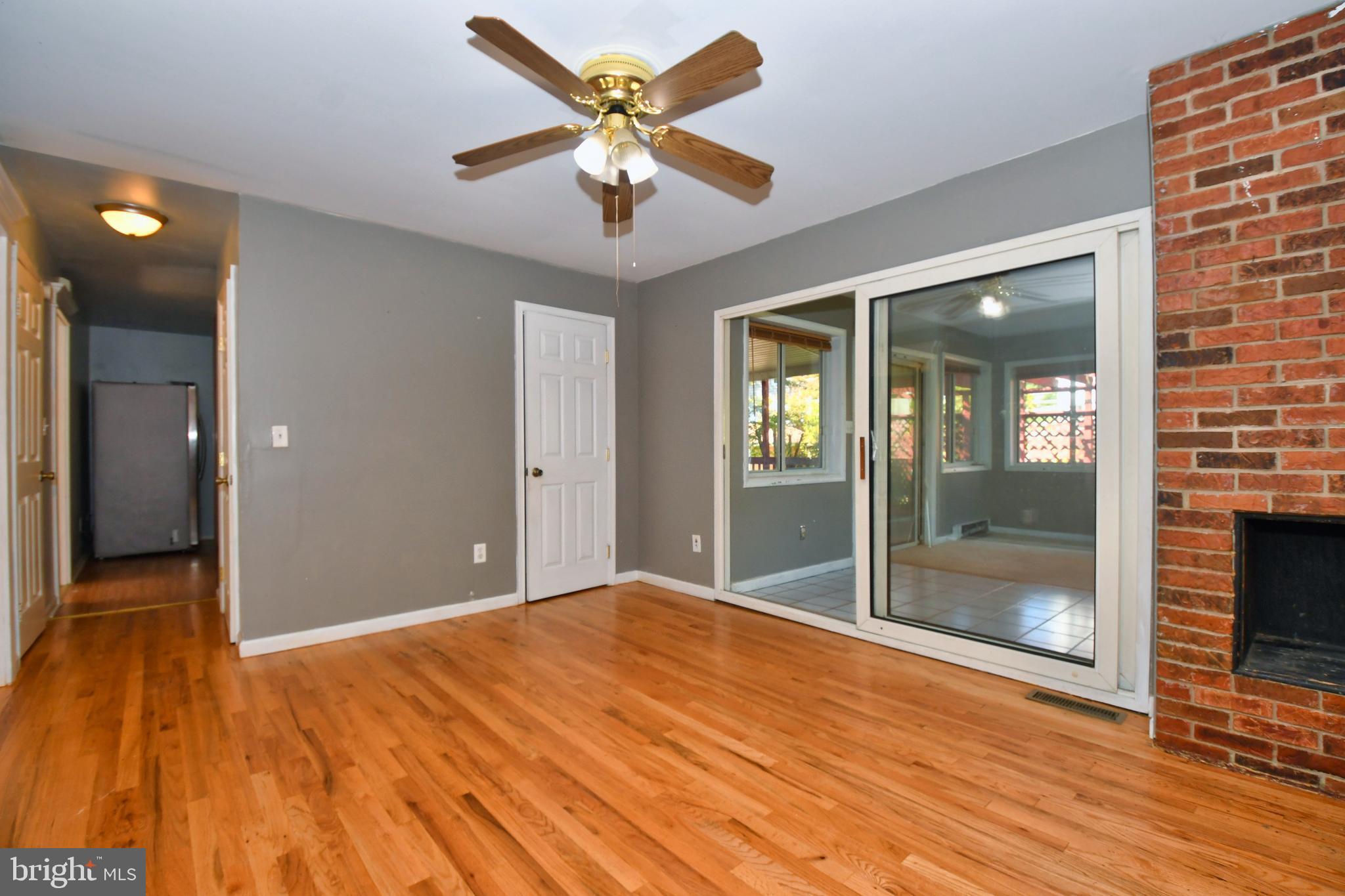 4704 Ebenezer Road Nottingham, MD 21236 - Photo 7 of 56 a view of a big room with wooden floor and a ceiling fan