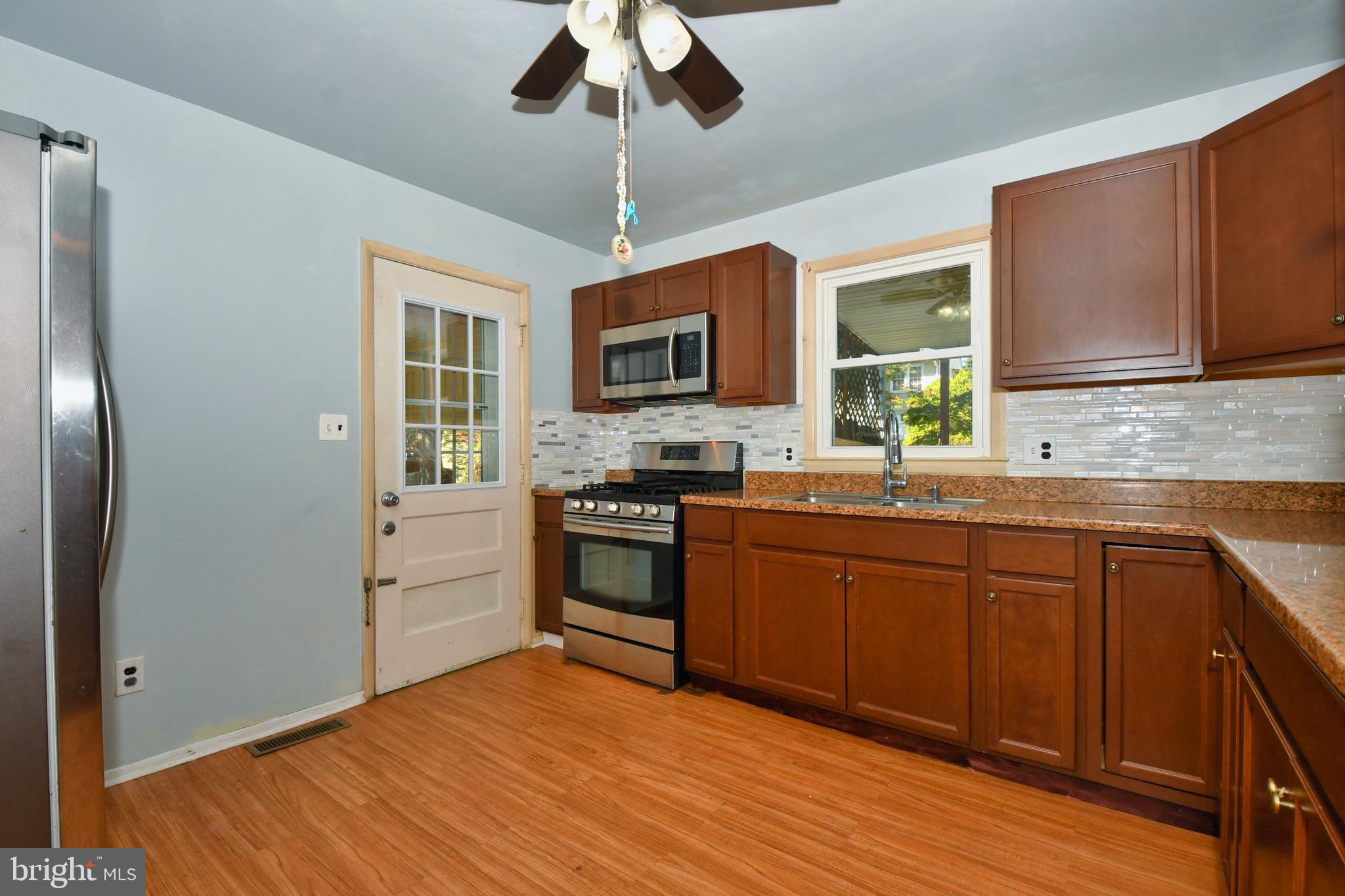 4704 Ebenezer Road Nottingham, MD 21236 - Photo 8 of 56 a kitchen with stainless steel appliances granite countertop a stove cabinets and wooden floor