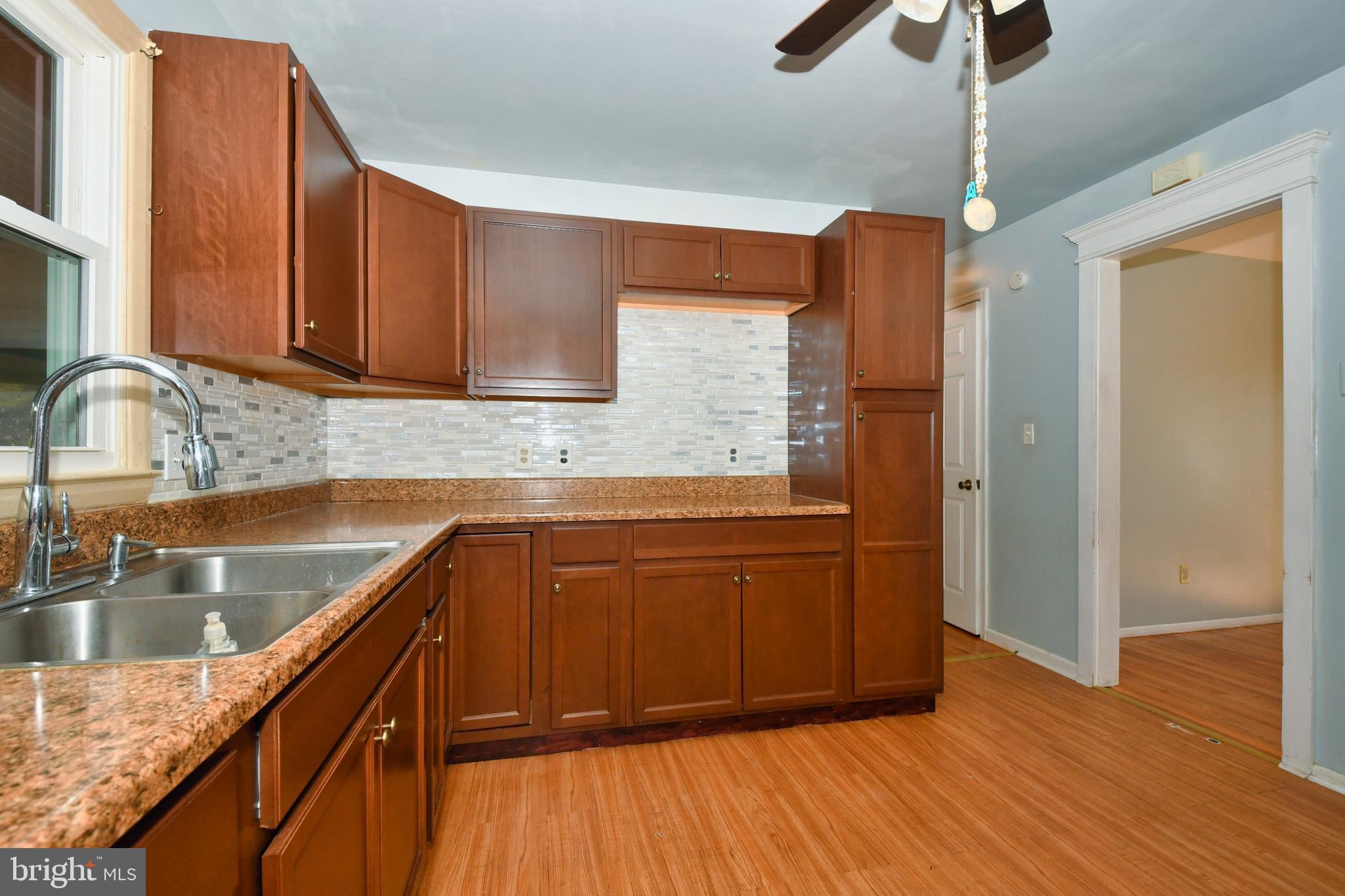 4704 Ebenezer Road Nottingham, MD 21236 - Photo 9 of 56 a kitchen with stainless steel appliances granite countertop wooden cabinets a sink and dishwasher