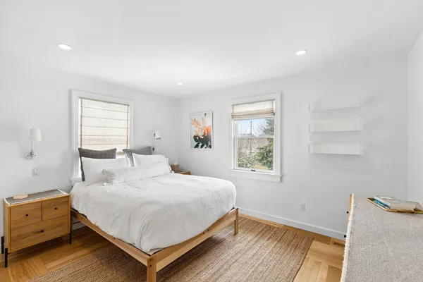 a bedroom with a bed and window