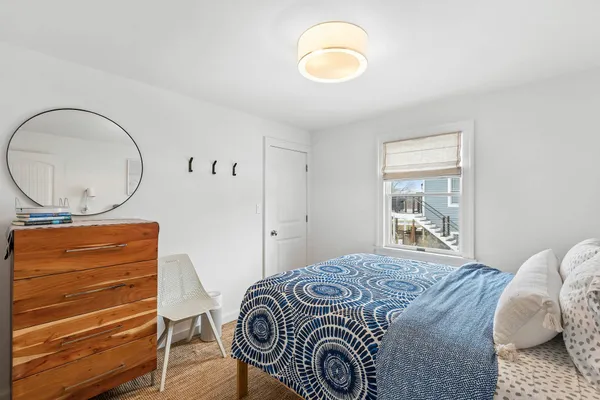 a bedroom with a bed and a mirror