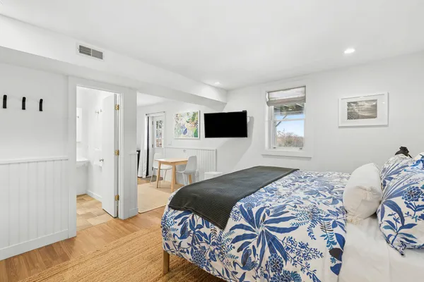 a bedroom with a bed and a flat screen tv
