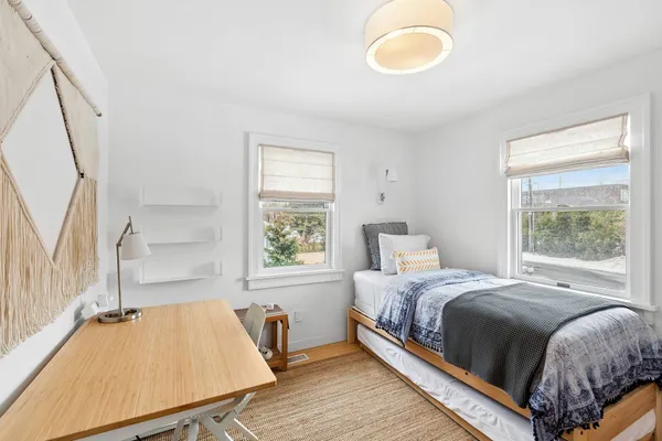 a bedroom with a bed and window