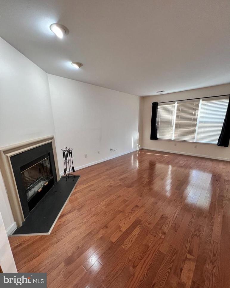 3303 Sterling Road Yardley, PA 19067 - Photo 2 of 16 a view of an empty room with wooden floor and a fireplace