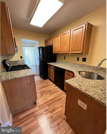 a kitchen with a sink stove and refrigerator