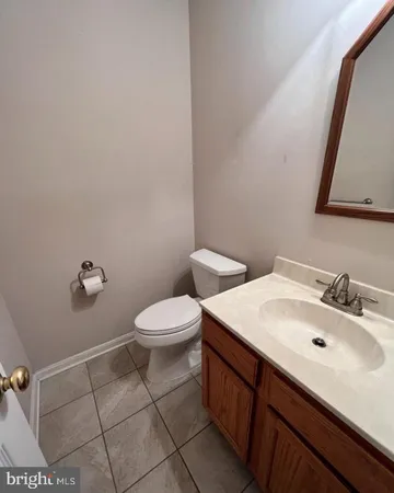 a bathroom with a sink mirror and toilet