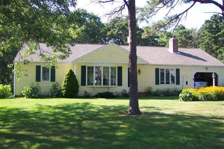 101 Ansel Howland Road Centerville, MA 02632 - Photo 2 of 23 a front view of a house with a yard and green space