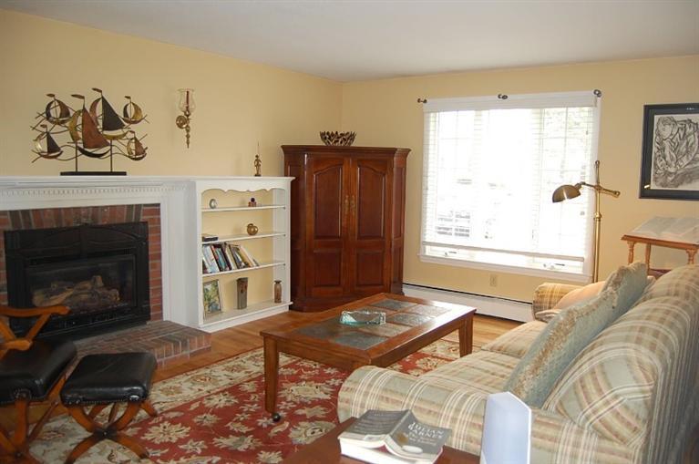 101 Ansel Howland Road Centerville, MA 02632 - Photo 8 of 23 a living room with a couch and a fireplace