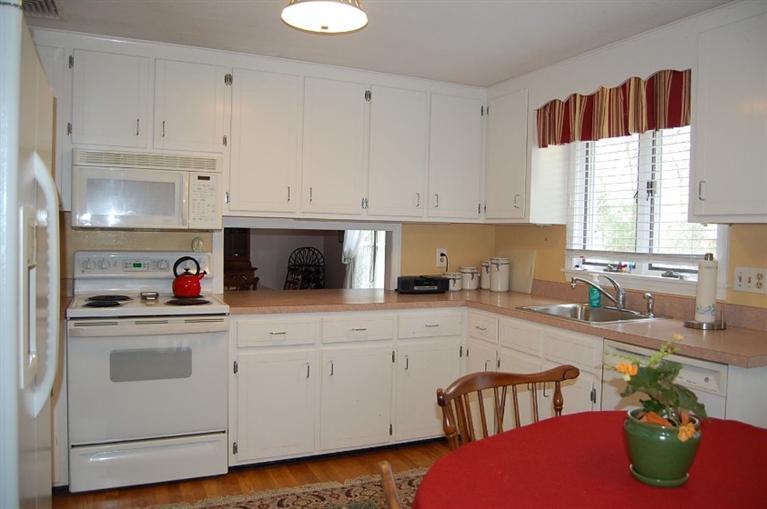 101 Ansel Howland Road Centerville, MA 02632 - Photo 10 of 23 a kitchen with stainless steel appliances granite countertop a sink a stove and white cabinets