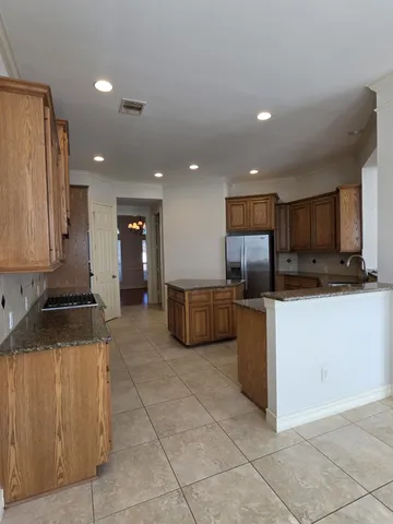 a kitchen with a refrigerator and a sink