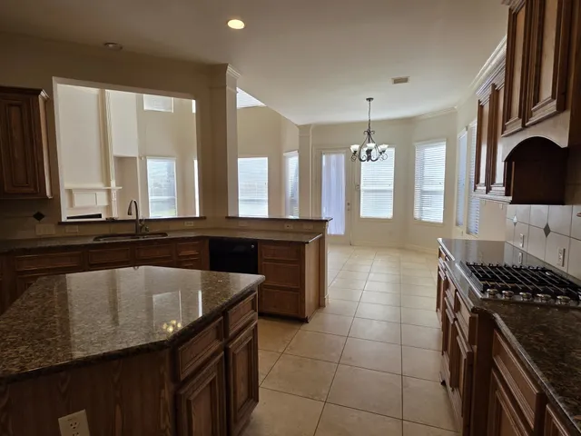 a kitchen with a sink and a stove top oven