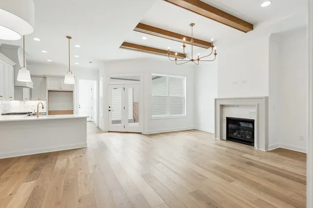 a view of a kitchen with kitchen island and stainless steel appliances