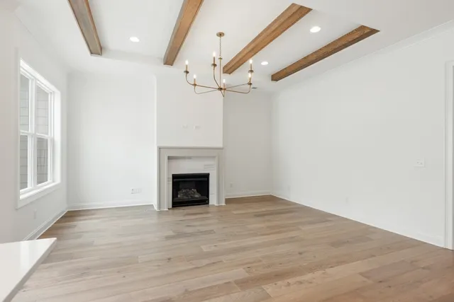 wooden floor in an empty room with a fireplace