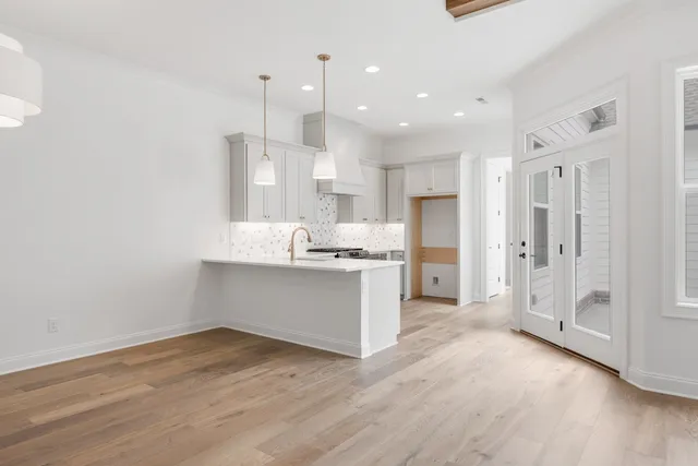a large kitchen with a lot of counter space and a refrigerator