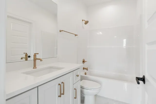 an empty room with a window and ceiling fan