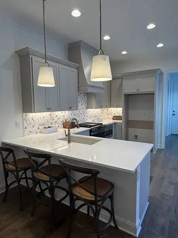 a kitchen with granite countertop white cabinets and white appliances