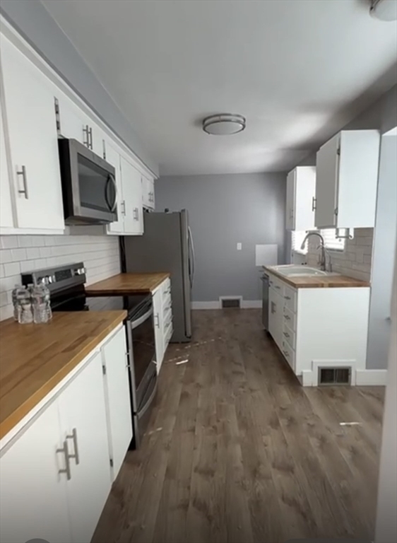 29 Tylee Avenue Worcester, MA 01605 - Photo 5 of 13 a kitchen with stainless steel appliances a sink stove top oven and refrigerator
