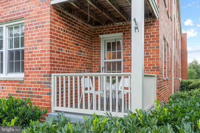 a view of a brick house with plants