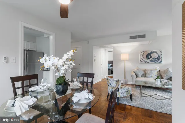 a living room with furniture chandelier and view kitchen