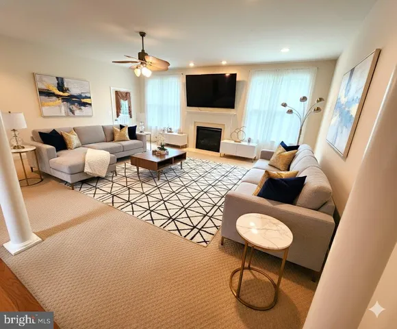 a living room with furniture a fireplace and a flat screen tv