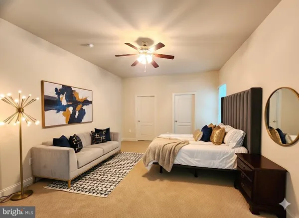 a bedroom with bed and a couch