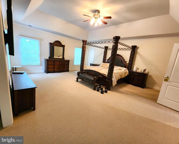 a spacious bathroom with a tub a double vanity sink a vanity a window and a mirror