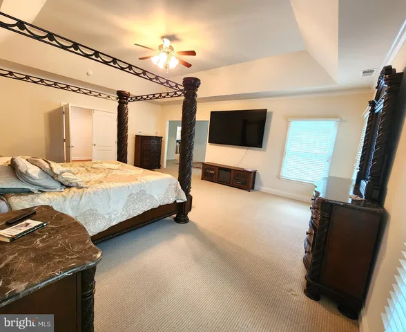 a spacious bathroom with a tub sink and mirror