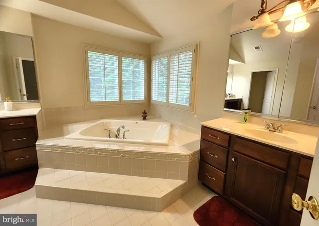 a bedroom with a bed and a ceiling fan