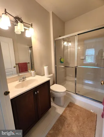 a bathroom with a sink a toilet and mirror