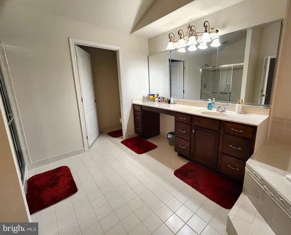 a bedroom with a bed and a ceiling fan