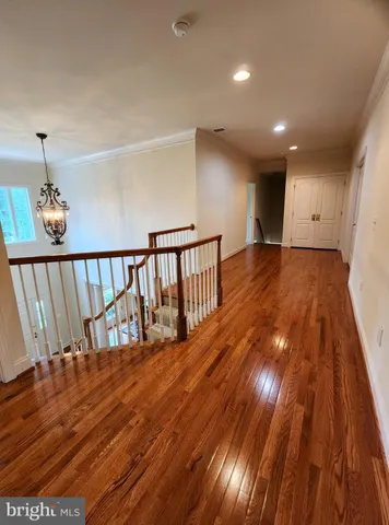 a view of hallway with wooden floor