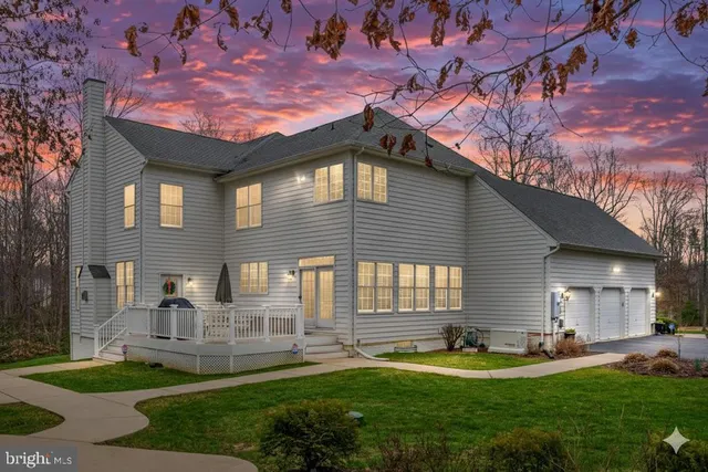 a front view of a house with swimming pool yard and patio