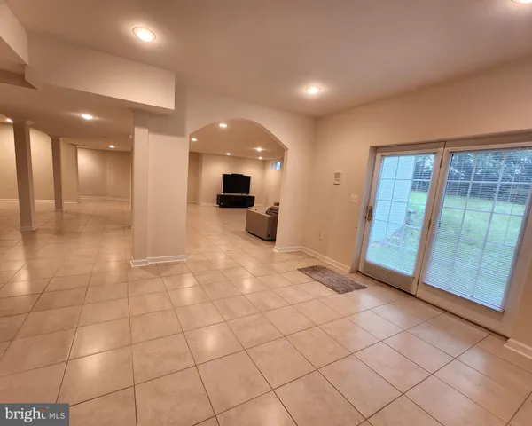 a living room with couches and a flat screen tv