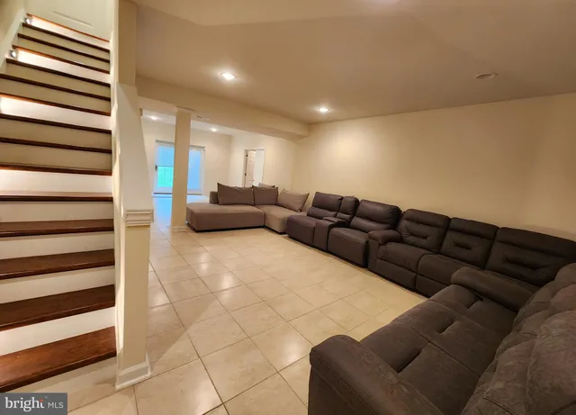 a living room with couches and a flat screen tv