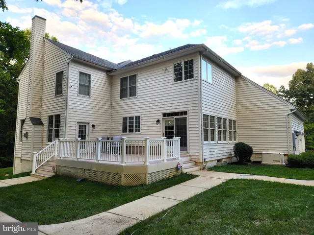 a view of house with a backyard and a garden
