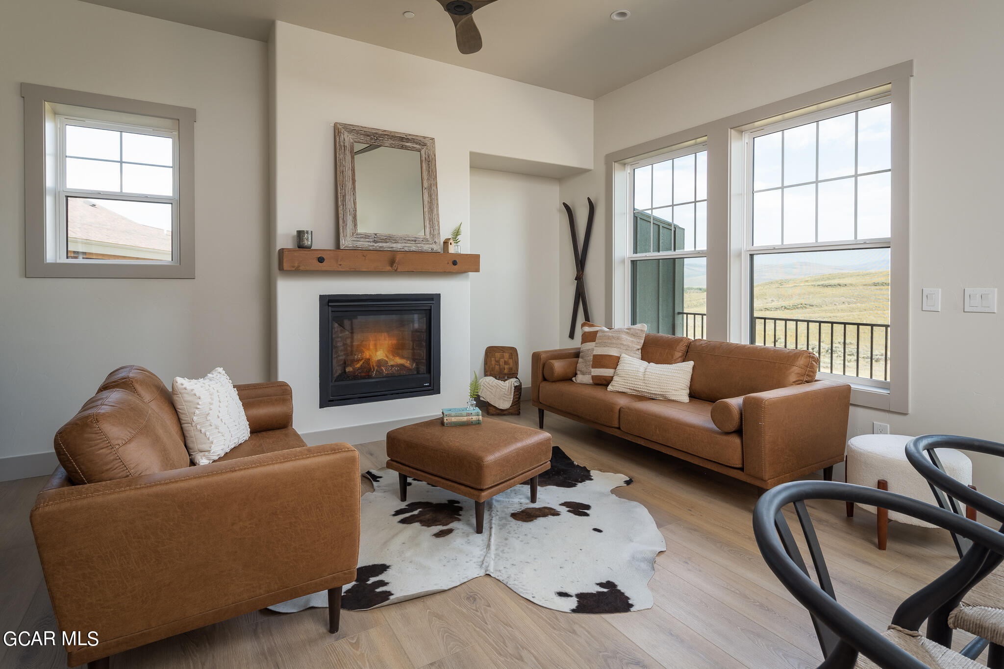 a living room with furniture a fireplace and window