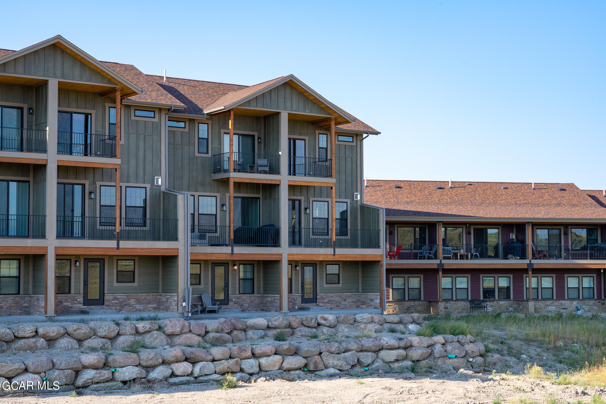 223 Eagle Ridge Circle Granby, CO 80446 - Photo 36 of 41 a front view of a house with glass windows and a yard