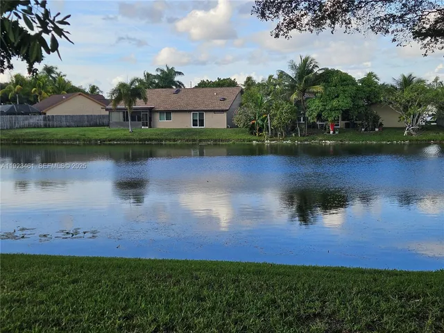 an aerial view of a house with swimming pool and outdoor space