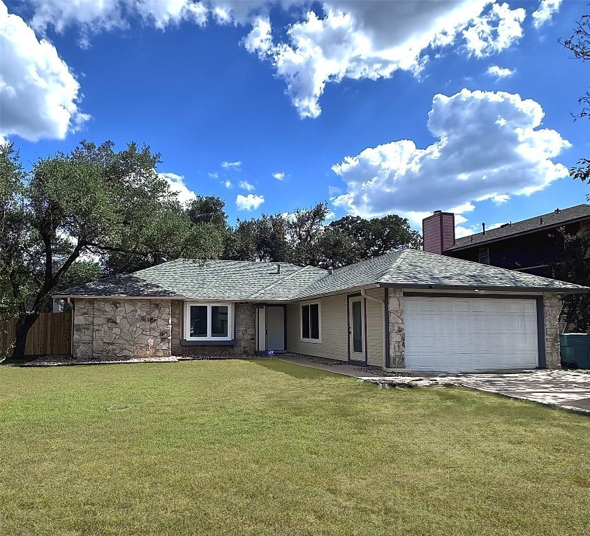 a front view of a house with a garden and yard