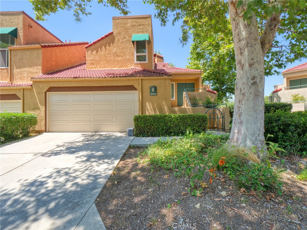 2910 Malaga Circle, Unit A Diamond Bar, CA 91765 - Photo 1 of 52 a front view of a house with a yard and garage
